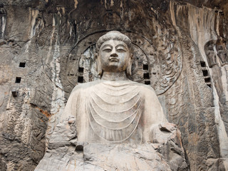 Fototapeta na wymiar Sitting Buddha statue in Longmen Grottoes