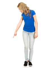 Fototapeta premium Beautiful young woman pointing down.