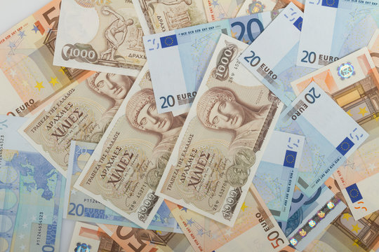 Old Greek 1000 drachmas banknotes and euro bills.