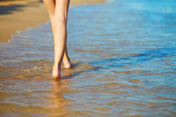 Beautiful woman walking on the beach
