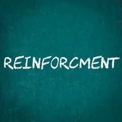 REINFORCMENT written on chalkboard