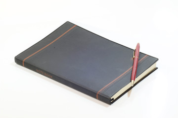 Black notebook on a white background.