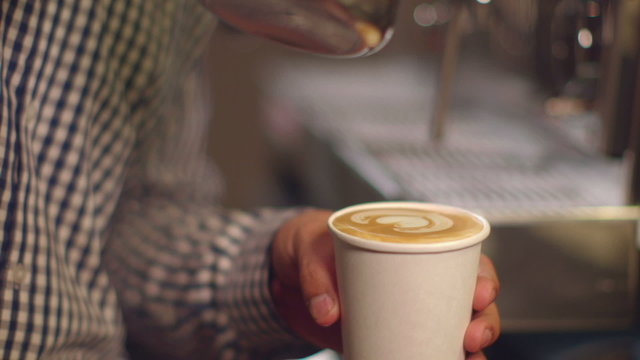 Freshly prepared latte in a take away cup