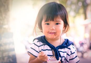 Cute little girl is eating icecream