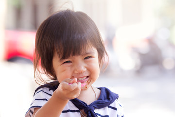 Cute little girl is eating icecream