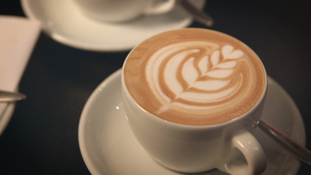 Pan from cake to a freshly prepared cup of latte