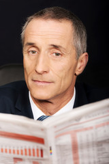 Businessman reading a newspaper in the office