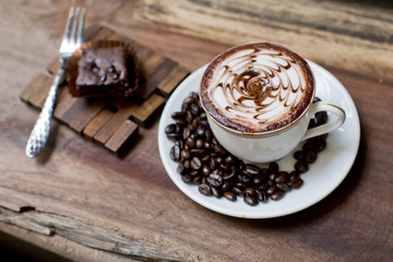 Cup of latte coffee with brownie cake
