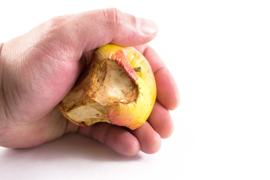Adult Hand Clenching an Old Apple.
