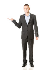 Smiling businessman holding copyspace