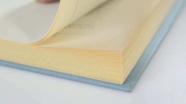 Closeup of the pages of a book being flipped