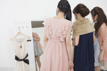服を選ぶ女性 © milatas