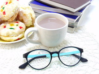 books in a mess and glasses isolated on white background