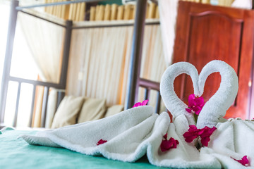 Fototapeta na wymiar towel decoration in hotel room, towel birds, swans, room interio
