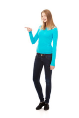 Young woman pointing to the left