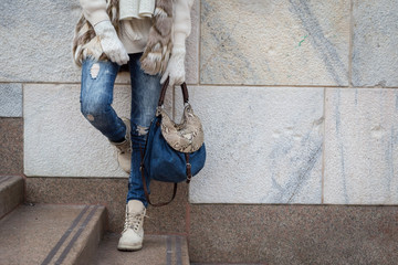 Detail of a young woman posing in the city streets