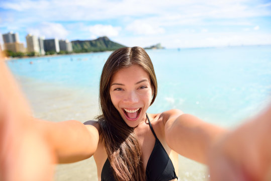 Selfie fun woman taking picture at beach vacation