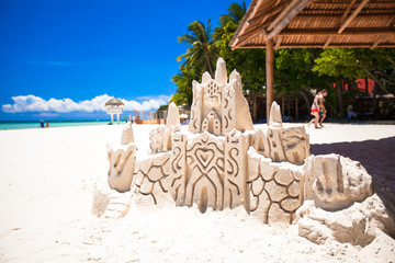 Sand castle on white tropical sandy beach