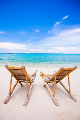 Beach chairs on perfect tropical white sand beach