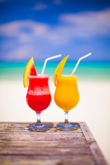 Two cocktails fresh watermelon and mango on background of