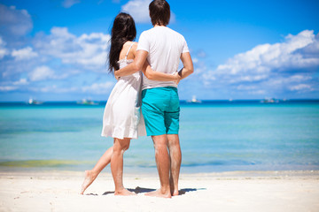Young couple on tropical beach during summer vacation