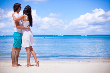 Young couple on tropical beach during summer vacation