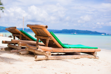 Fototapeta premium Beach chairs on exotic tropical white sandy beach