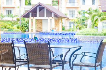 table and chairs in outdoor cafe, small restaurant at hotel pool