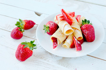 Pancakes with fresh strawberry fruits and castor sugar