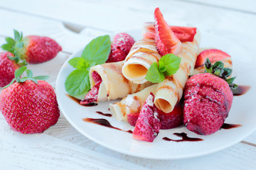 Pancakes with fresh strawberry fruits and chocolate topping