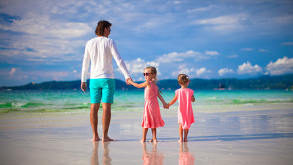 Father and little girls together during tropical vacation