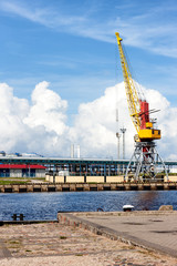 Fototapeta na wymiar Cargo crane in the port of the Baltic against the blue sky in su