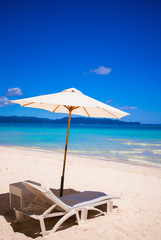 Beach chairs on perfect tropical white sand beach