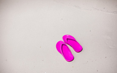 Colorful flipflop pair on sea beach