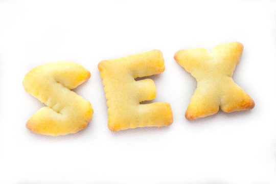 Cookies arranged in Sex Text on White Background