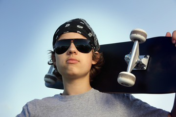 Young boy with skateboard in hand