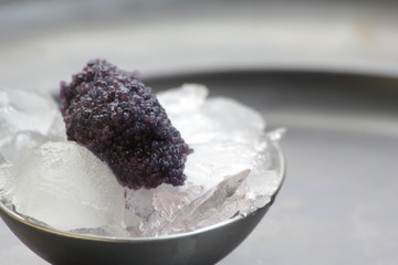 Closeup of black caviar on ice cubes.