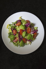 Fresh vibrant salad of lettuce, tomato, and basil