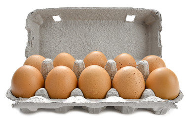 Cardboard egg box with ten brown eggs isolated on white.