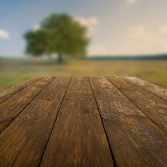 Wooden table outdoors with autumn field background