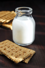 Organic crackers with bran and small bottle of milk