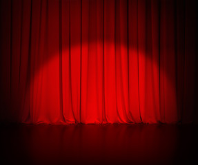 theatre red curtain or drapes background with light spot