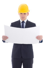 handsome business man in yellow builder's helmet with blueprint