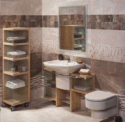 detail of a modern bathroom with sink, cabinet for towels and to