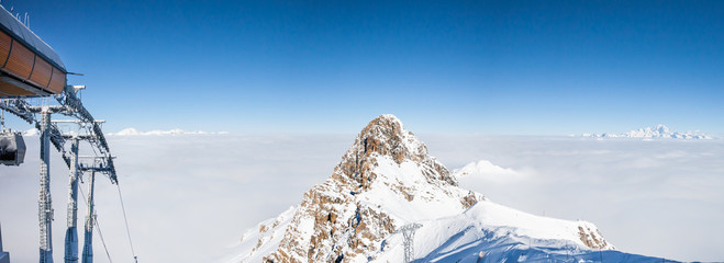 Mountain peak over the clouds in French Alps, Meribel