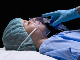 Girl in an operating room with anesthesia mask