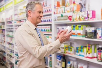 Fototapeta premium Smiling customer looking at medicine