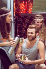 Hipster friends in camper van at festival