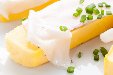 Crostoni di polenta gialla con fettine di  lardo