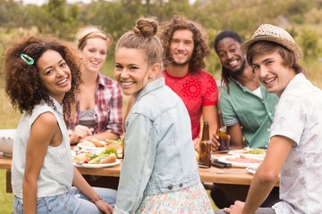 Happy friends in the park having lunch
